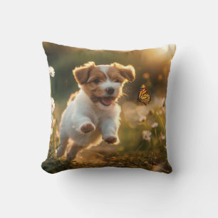 Cute little puppy chasing after a butterfly cushion