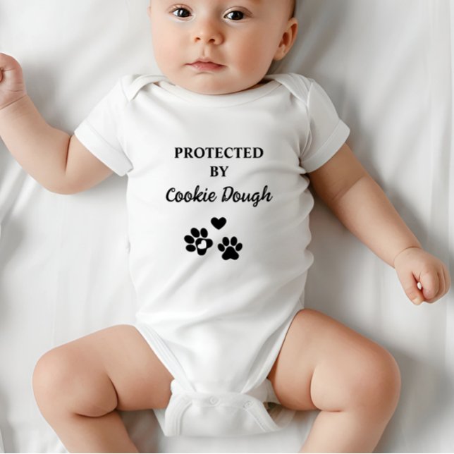 Cute Personalised Protected by Dog (Adorable baby bodysuit with "Protected by (Dog's Name)" design, featuring hearts and paw prints.)