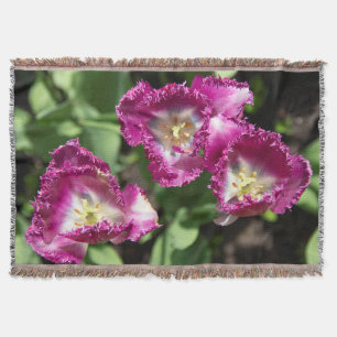 Cute purple tulips in the garden throw blanket