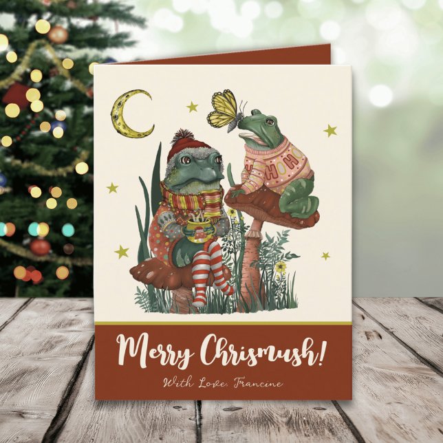 Cute Red Mushroom Frog and Toad Merry Christmas   Holiday Card (Whimsical Merry Christmas card with an illustration of frogs sitting on mushrooms drinking cocoa)