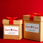 Cute Retro Red Santa Claus Desk Christmas Delivery Rectangular Sticker<br><div class="desc">Take your holiday greetings back in time with our Vintage Red and White Script Sticker! Inspired by the iconic lettering from Santa Claus's workshop, this label adds nostalgic charm to your Christmas mailings. Set against a crisp white background, the customisable text makes each label uniquely yours. Perfect for sealing envelopes,...</div>