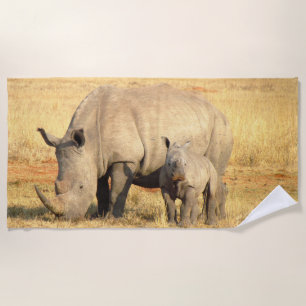Cute rhinoceros in africa beach towel