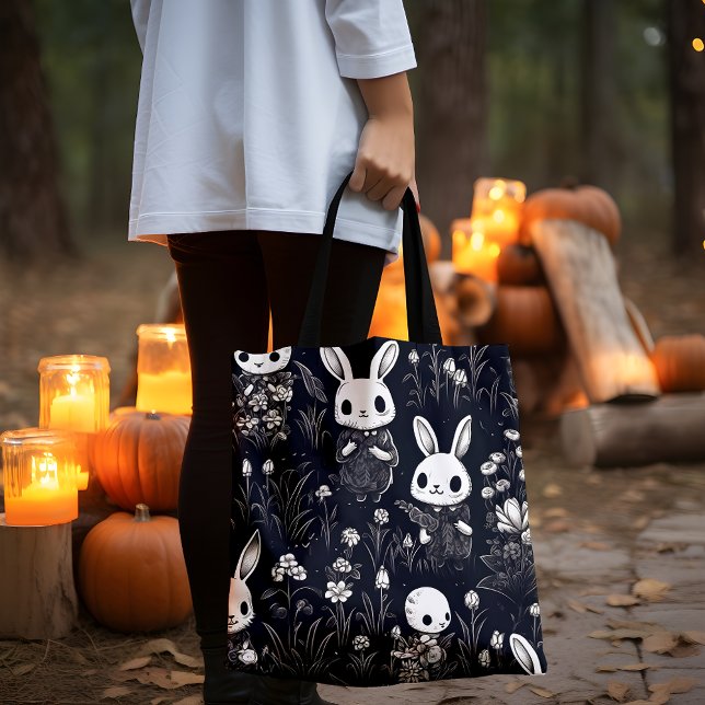 Cute Skeleton Bunnies Halloween Tote Bag (Lady holding a black and white Skeleton Bunnies  tote bag with pumpkins and candles.)