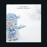 Cute Snowman in Winter Photograph Christmas Notepad<br><div class="desc">A notepad with a cute photograph of a little snowman. Standing outside in the winter with snow falling all around. This cute little guy is dressed up in blue knitted hat and scarf. Some white/grey bokeh flare in the background.</div>