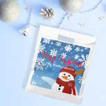 Cute Snowman Winter Wonderland Merry Christmas Favour Bags<br><div class="desc">Experience the joy of giving with our personalised Christmas favour bag. This charming favour bag, adorned with a jovial snowman set against a serene blue backdrop, captures the magic of a white Christmas. Each snowflake surrounding the snowman adds a touch of winter wonder, making it an enchanting sight to behold....</div>