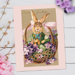 Cute Vintage Easter Bunny in Basket with Violets Postcard<br><div class="desc">Adorable vintage holiday art featuring whimsical brown Easter bunny in fancy suit and blue neck ribbon sitting in basket of violets tied with a pink ribbon. Easter Greetings in fancy script and tan background. Back features optional violet and bunny graphics and editable text and border colours.</div>