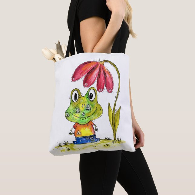 Cute Whimsical Green Frog Under a Red Flower Tote Bag (Close Up)