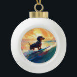 Dachshund Beach Surfing Painting Ceramic Ball Christmas Ornament<br><div class="desc">Immerse yourself in the playful world of canine adventure with this captivating painting. A spirited dog takes to the waves, skilfully riding the surf on a sun-kissed beach. The vibrant artwork beautifully captures the essence of beachside excitement as the dog fearlessly rides the waves, embodying the spirit of fun and...</div>