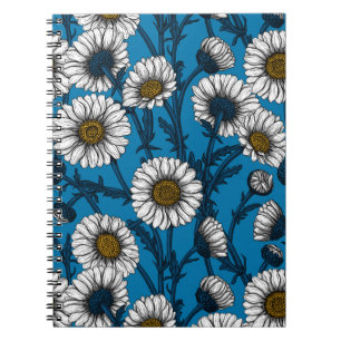 Daisies on blue notebook