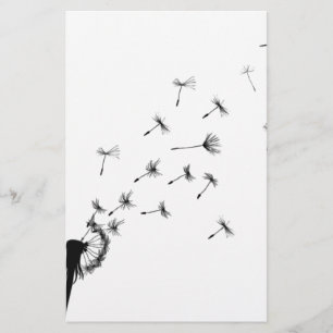 Dandelion puff in the wind