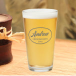 Dark Grey Stylised Wedding Groomsman Name Glass<br><div class="desc">Beer glass for the wedding groomsman that features his name printed in a dark grey, stylised script inside a dark grey bordered oval along with wedding date. A great party supply idea for a bachelor party! Personalise your beer glass by editing and replacing name and date with your own. Available...</div>