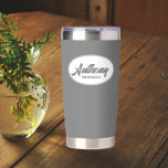 Dark Grey Stylised Wedding Groomsman Name Insulated Tumbler<br><div class="desc">Gift your wedding groomsman with this trendy and personalised,  stainless steel,  thermal tumbler with his name in stylised script in a white oval design. Background and script is a dark grey colour. Personalise your thermal tumbler by editing and replacing groomsman's name with desired name.</div>