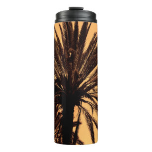 Dark silhouettes of date palms against bright colo thermal tumbler