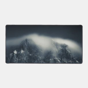 Darkness and white clouds over the mountains desk mat