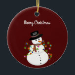Dated Merry Christmas Snowman Personalised Ceramic Tree Decoration<br><div class="desc">Cute snowman is tangled with lit Christmas lights, has the year on his hat - The "Merry Christmas" text above can be changed or added to, and the font style/size can also be changed. Shown on a deep red background, which can be changed to any colour you prefer. The ornament...</div>