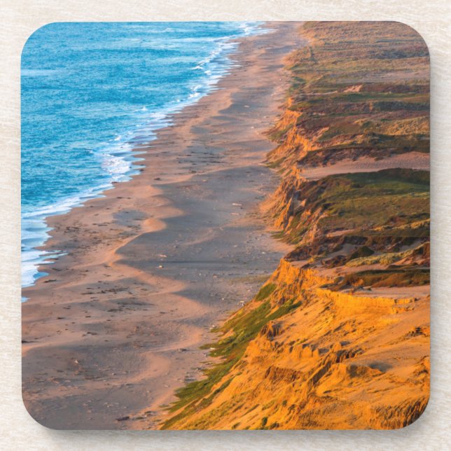 Days Last Light Strikes The Sandy Shore Of Point Coaster (Front)