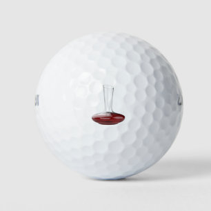 Decanter with red wine golf balls