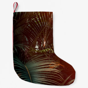 Deep dark green palm leaves pattern with bright or small christmas stocking