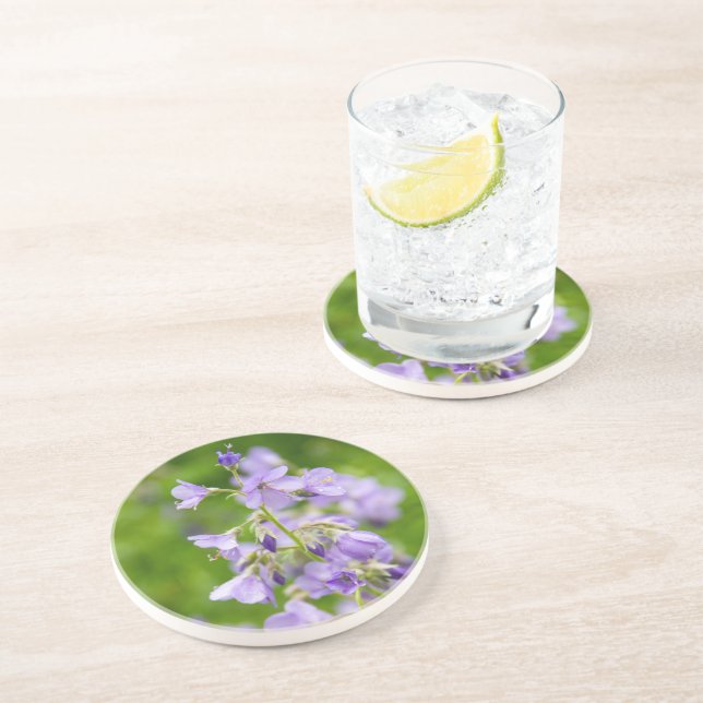 Delicate blue flowers on a green field in a spring coaster (Side)