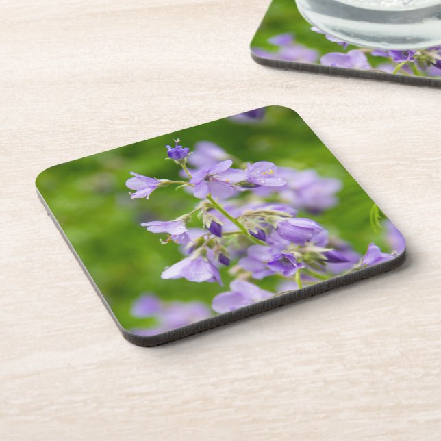 Delicate blue flowers on a green field in a spring coaster (Left Side)