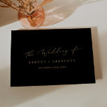Delicate Gold and Black Monogram Back Wedding Guest Book<br><div class="desc">This delicate gold and black monogram back wedding guest book is perfect for a modern wedding. The romantic minimalist design features lovely and elegant champagne golden yellow typography on a black background with a clean and simple look. Personalize the front cover with the names of the bride and groom and...</div>