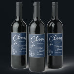 Delicate orchids cheers to the wedding blue custom wine label<br><div class="desc">Elegant customisable wine labels for your wedding reception, featuring beautiful and delicate white orchids line drawing on one side, over a classic Prussian blue background, and the wording "Cheers to the wedding of" in white fonts. Easily edit the template fields to add the bride and groom names in a classy...</div>
