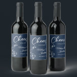 Delicate orchids cheers to the wedding blue custom wine label<br><div class="desc">Elegant customisable wine labels for your wedding reception, featuring beautiful and delicate white orchids line drawing on one side, over a classic Prussian blue background, and the wording "Cheers to the wedding of" in white fonts. Easily edit the template fields to add the bride and groom names in a classy...</div>