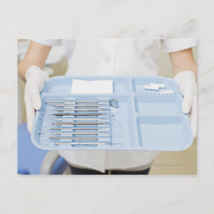 Dental hygienist holding tray of dental postcard