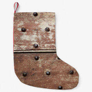 Detail of an old painted shabby door with rusty me small christmas stocking