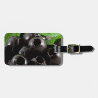 Detailed close-up view of the black olives luggage tag