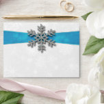 Diamante Snowflake & Blue Ribbon Winter Wedding Envelopes<br><div class="desc">The diamante snowflake & blue ribbon wedding collection is perfect for any couple planning a romantic winter wedding celebration. The design features a light silvery grey and white snowflake textured background with a diamante snowflake on top of a silky looking ribbon. The wording incorporates the same silvery grey and blue...</div>
