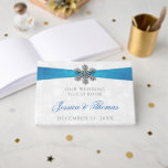 Diamante Snowflake & Blue Ribbon Winter Wedding Guest Book<br><div class="desc">The diamante snowflake & blue ribbon wedding collection is perfect for any couple planning a romantic winter wedding celebration. The design features a light silvery grey and white snowflake textured background with a diamante snowflake on top of a silky looking ribbon. The wording incorporates the same silvery grey and blue...</div>