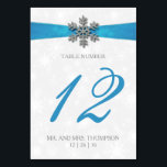 Diamante Snowflake & Blue Ribbon Winter Wedding Table Number<br><div class="desc">The diamante snowflake & blue ribbon wedding collection is perfect for any couple planning a romantic winter wedding celebration. The design features a light silvery grey and white snowflake textured background with a diamante snowflake on top of a silky looking ribbon. The wording incorporates the same silvery grey and blue...</div>