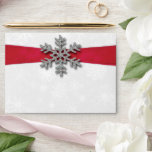 Diamante Snowflake & Red Ribbon Winter Wedding Envelope<br><div class="desc">The diamante snowflake & red ribbon wedding collection is perfect for any couple planning a romantic winter wedding celebration. The design features a light silvery grey and white snowflake textured background with a diamante snowflake on top of a silky looking ribbon. The wording incorporates the same silvery grey and red...</div>