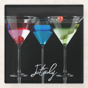 Different cocktails in martini glasses on black glass coaster