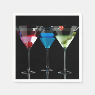 Different cocktails in martini glasses on black napkin