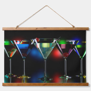 Different cocktails in martini glasses with lights hanging tapestry