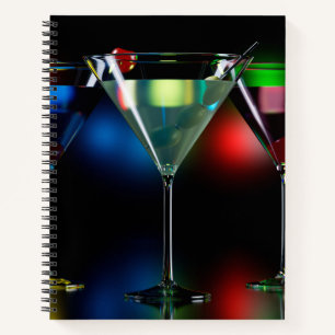 Different cocktails in martini glasses with lights notebook