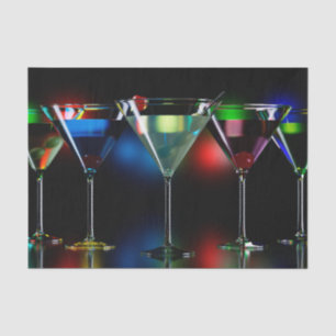 Different cocktails in martini glasses with lights tissue paper