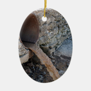 Dirty water flows from a brown rusty sewer pipes ceramic tree decoration