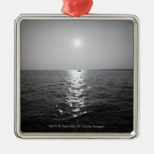 Distant boat on ocean metal tree decoration