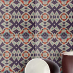 Distressed Stone Texture Ethnic Mosaic Geometric Tile<br><div class="desc">This ceramic tile is adorned with a mesmerising geometric pattern that exudes a sense of cultural richness and artistic flair. The design features a symmetrical array of shapes that draw inspiration from tribal or ethnic motifs, creating a tapestry of visual intrigue. The colour palette is a sophisticated blend of purple,...</div>