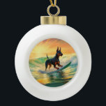 Doberman Beach Surfing Painting Ceramic Ball Christmas Ornament<br><div class="desc">Immerse yourself in the playful world of canine adventure with this captivating painting. A spirited dog takes to the waves, skilfully riding the surf on a sun-kissed beach. The vibrant artwork beautifully captures the essence of beachside excitement as the dog fearlessly rides the waves, embodying the spirit of fun and...</div>