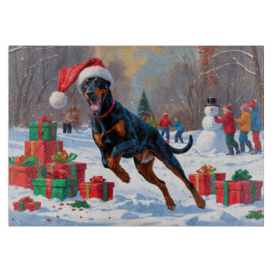 Doberman Running in Snow with Christmas Hat Cutting Board