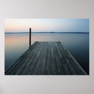 Dock over calm water at dawn poster