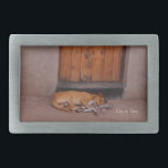 Dog at Rest Belt Buckle<br><div class="desc">Dog at Rest Nature Photo prints and gifts feature a beautiful photograph of tan dog sleeping in front of a mud hut with an orange door in Africa taken by Kurt Keller in the afternoon while on an African safari. Anyone who loves animals, dogs, nature photography and any puppy lovers...</div>