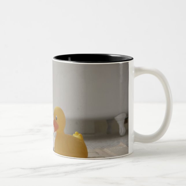 Dog on mat with plastic duck Two-Tone coffee mug (Right)