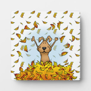 Dog Playing in a Pile of Fall Leaves - Cute Autumn Plaque