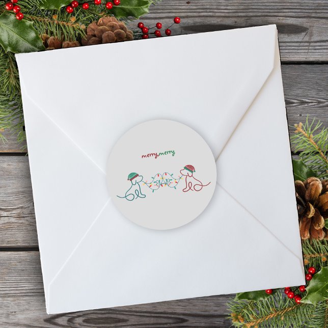 Dogs Playing with Christmas Lights Party Classic Round Sticker (Dress up your packages, presents and envelopes with festive holiday stickers! Merry Merry Christmas!)