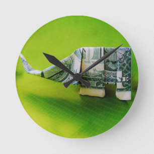 Dollar bill origami Elephant on Green background Round Clock